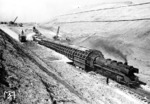 Der Braunhäuser Tunnel war ein 293 m langer Eisenbahntunnel an der Nord-Süd-Strecke bei Asmushausen, nordöstlich von Bebra. Als die Nord-Süd-Strecke im Jahr 1961 von der Deutschen Bundesbahn elektrifiziert wurde, musste der Tunnel abgebrochen werden, weil seine Bauhöhe für die zu verlegenden Oberleitungen nicht ausreichte. Hier passiert eine Lok der Baureihe 41 die Baustelle.  (03.05.1962) <i>Foto: Först</i>
