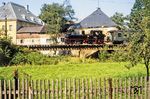 Der P 14287 nach Jöhstadt mit 99 1561 fährt an der Papierfabrik Pursche in Steinbach (bei Jöhstadt) vorbei.  (07.1982) <i>Foto: Karsten Risch</i>