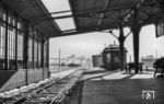Der Bahnhof Rendsburg im Winter 1952. Der Blick geht Richtung Süden auf die Hochbrücke und den damals noch vorhandenen Güterbahnhof. Rechts davon befand sich ein Bahnbetriebswerk mit einem sechsständigen Lokschuppen und einer 17-Meter-Drehscheibe, das 1954 als selbstständige Dienststelle aufgelöst wurde. Das Bw gehörte zum Maschinenamt Flensburg und war mit 60 Mitarbeitern die kleinste der vier Dienststellen des Maschinenamtes.  (01.1952) <i>Foto: Slg. Thorsten Eichhorn</i>