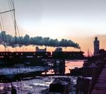Im Abendrot dampft eine unbekannte Altonaer 012 vor dem D 533 nach Westerland (Sylt) über die Klappbrücke am Husumer Hafen. (22.12.1971) <i>Foto: Ulrich Hesse</i>