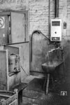 Archaische Waschgelegenheit im Raw Görlitz. An der Wand hängt eine Gastherme des VEB-Kombinats Haushaltgeräte Karl-Marx-Stadt, mit der wohl das warme Wasser für den links stehenden Teekessel erzeugt wurde.  (30.07.1985) <i>Foto: Heiko Kußmann</i>