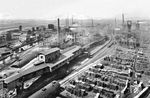 Blick auf das Steinkohlenbergwerk "Zeche Carolinenglück" in Bochum-Hamme. Im Jahre 1929 wurde die höchste Fördermenge der Zeche mit 807.500 Tonnen Kohle erreicht. Beachtenswert ist auch die große Menge von Grubenholz, dass auf dem Zechengelände lagert. 1963 wurden mit nur 1.497 Beschäftigten noch 488.240 Tonnen Kohle gefördert. Die Zeche wurde am 31. Mai 1964 stillgelegt. 1968 wurde auch die Kokerei auf dem Werksgelände stillgelegt und abgerissen. Heute erinnert an die Zeche – außer dem gleichnamigen Gewerbegebiet – nur noch das 1912 über Schacht 3 errichtete Strebengerüst der Bauart Zschetzsche sowie der 1856 über Schacht 2 errichtete und durch Umbauten veränderte Malakow-Turm. Beide Schächte werden nach wie vor zur Wasserhaltung genutzt.  (1935) <i>Foto: RVM</i>