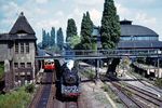 Mit einem Schnellzug aus Stralsund rollt 03 0048 durch den S-Bahnhof Berlin Pankow-Heinersdorf. Rechts der letzte in Deutschland gebaute Rundlokschuppen aus dem Jahr 1893. Seit dem Abriss des Rundlokschuppens in Paderborn 1978 existieren in Deutschland gerade noch zwei Bauten dieser Art. Neben dem Gebäude in Pankow befindet sich ein zweites Rundhaus auf dem Rangierbahnhof in Berlin-Rummelsburg. Hier wie dort ist der Zustand dieser einmaligen Industriedenkmäler äußerst kritisch. Würden sie nicht beide unter Denkmalschutz stehen, hätte die Deutsche Bahn als Eigentümer sie vermutlich schon längst abgerissen. Für das Bauwerk in Rummelsburg wurde bereits 2010 ein Abrissantrag gestellt, der allerdings abgelehnt wurde. (08.08.1976) <i>Foto: Dr. Uwe Knoblauch</i>