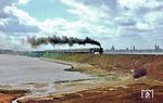 Vor der Silhouette der Hansestadt Stralsund mit den drei Kirchen St. Marien, St. Jakobi und St. Nikolai bringt 03 0085 den internationalen Schnellzug D 270 "Meridian" über den Strelasund nach Rügen.  (30.04.1979) <i>Foto: Wolfgang Bügel</i>