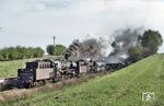 50 1823 (ex 50 823 vom Bw Reichenbach/Vogtl, Est Werdau) und 50 1812 vom Bw Karl-Marx-Stadt mit einem Güterzug bei Werdau (Sachsen). (19.04.1974) <i>Foto: Robin Fell</i>